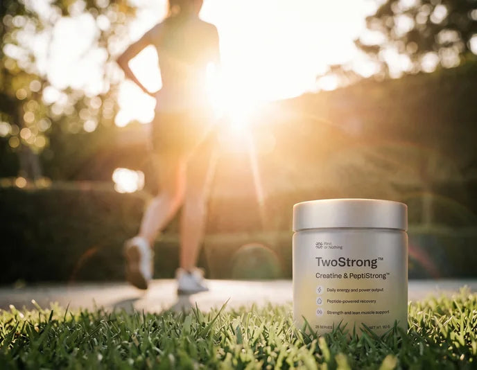 A jar of TwoStrong on the grass, a runner in the sun behind it