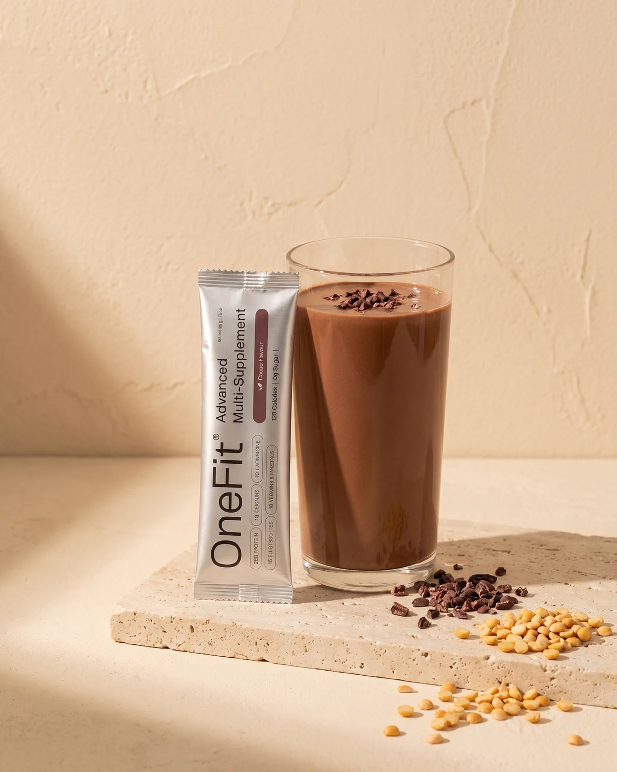A single Clean Lean Protein Cacao sachet standing on a warm cream ground in soft golden light