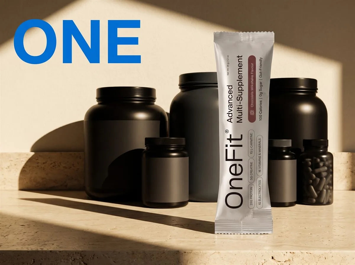 One. A single OneFit Advanced Multi-Supplement sachet in front of the five bulky, unlabelled black supplement tubs it replaces