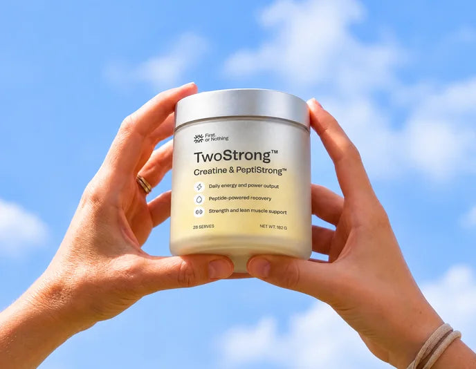 Holding a jar of TwoStrong up to the sky