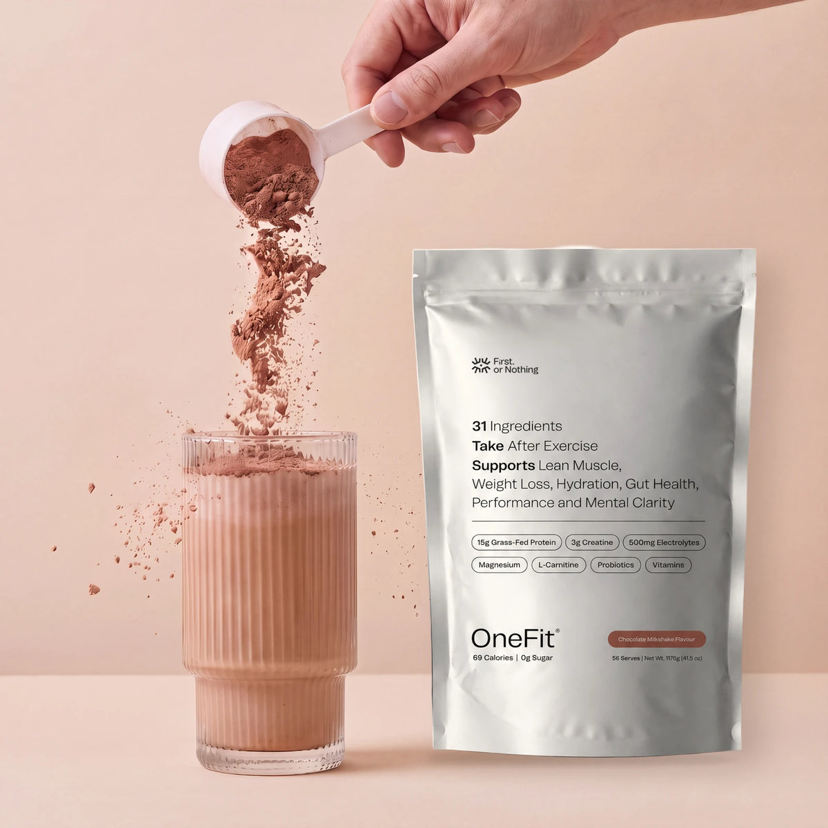 A scoop of OneFit Chocolate Milkshake poured into a glass beside the OneFit pouch