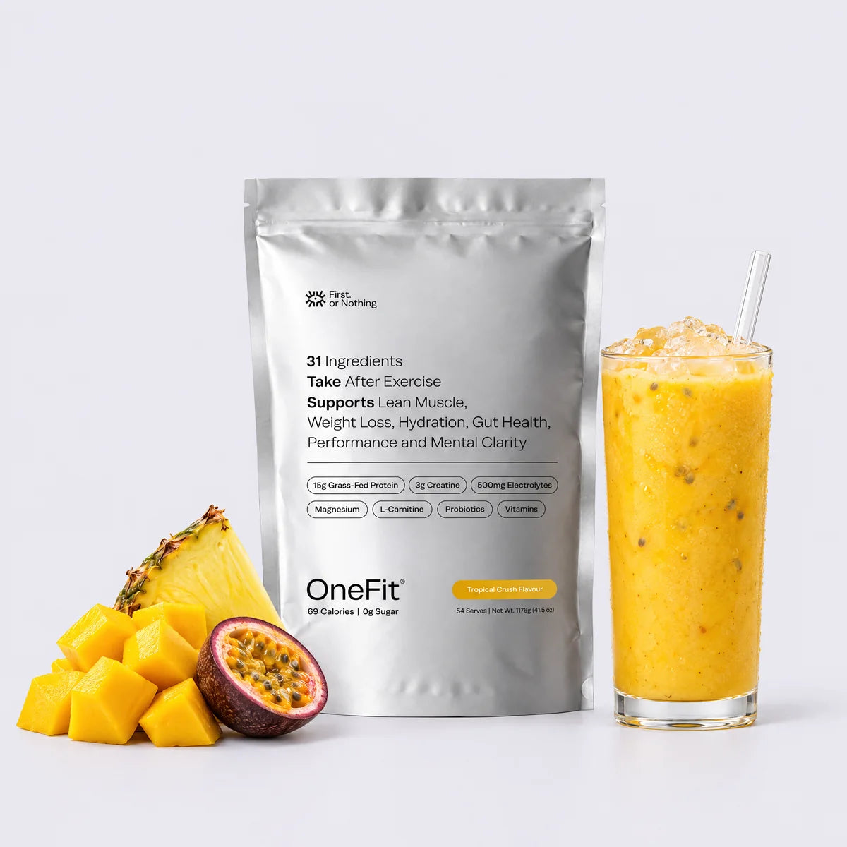 The OneFit 4.7 Tropical Crush pouch beside a mango smoothie, mango cubes, pineapple and passionfruit