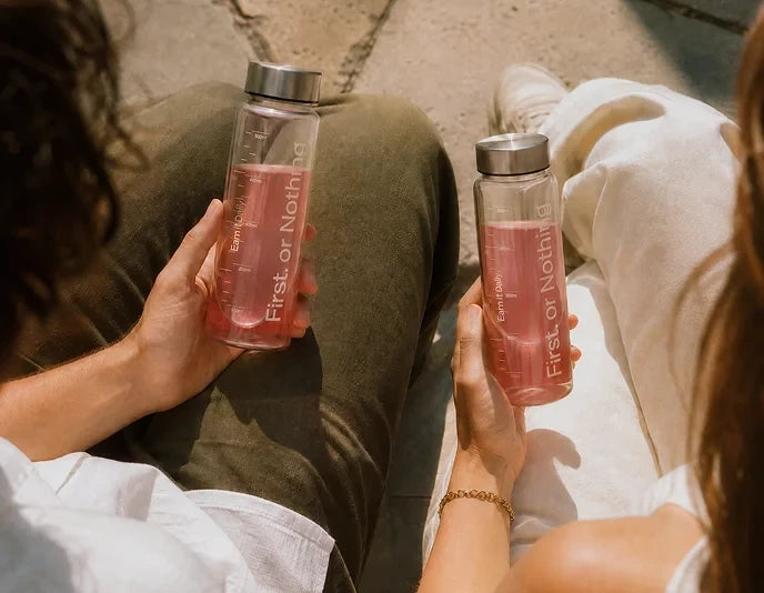 Two people holding their OneLife drinks